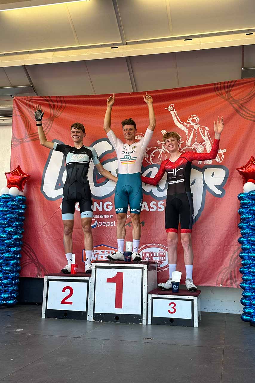 Winners of a 2024 LaGrange Cycling Classic heat celebrate on the podium.